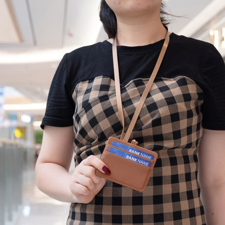 Brown horizontal ID card holder with lanyard on a person, clear card window