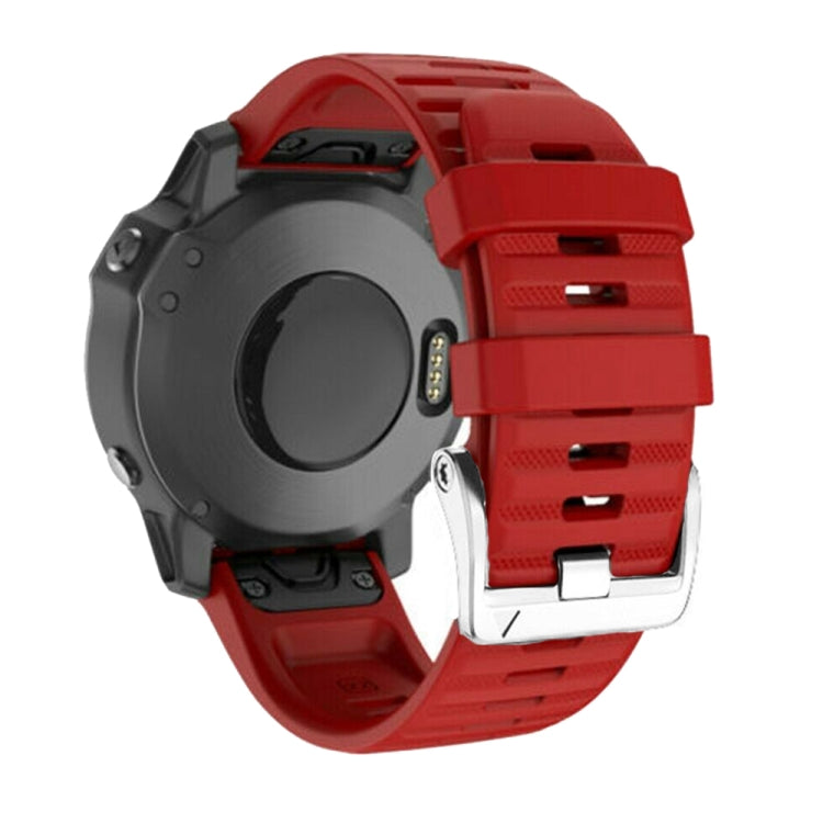 Red silicone watch band with silver steel buckle, clasp and strap end close-up