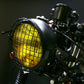 Motorcycle retro LED headlight accessory with yellow-lit lamp and wire mesh guard