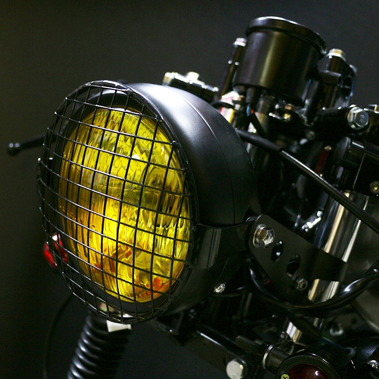 Motorcycle retro LED headlight accessory with yellow-lit lamp and wire mesh guard
