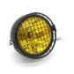 Motorcycle retro LED headlight with black housing, wire mesh guard, yellow lens light