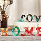 “Love” resin letter keychain set in orange, teal, green, red, and pink