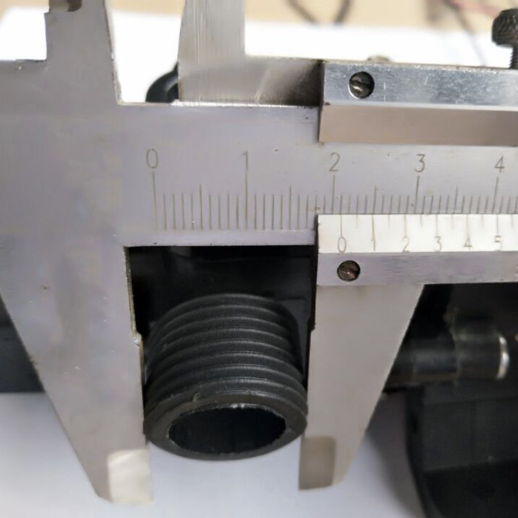 Threaded pump outlet fitting with ribbed connector, shown with caliper measurement