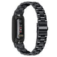 Black stainless steel watch band showing side clasp and linked three-bead flat design