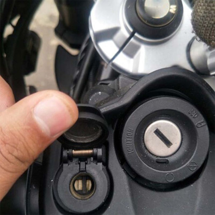 Black motorcycle USB charger close-up with safety cover and mounting hole