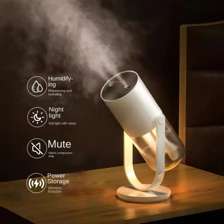 White wireless humidifier on tabletop stand with warm glow, releasing mist.