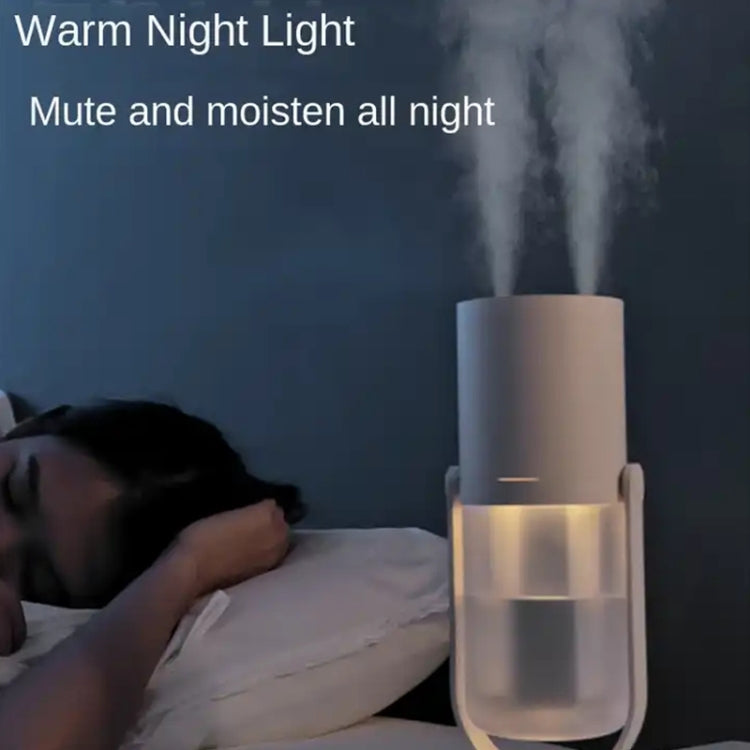 Warm night light humidifier with white body and mist, placed on bedside table.