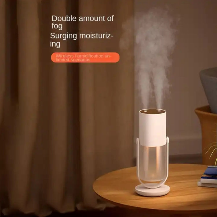 White wireless humidifier on round base releasing steady mist from top opening.