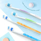 Soft toothbrushes set with white heads and blue, orange, and purple handles.