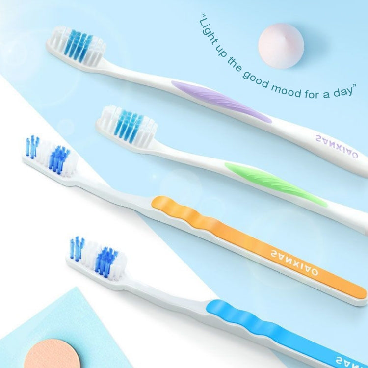 Soft toothbrushes set with white heads and blue, orange, and purple handles.