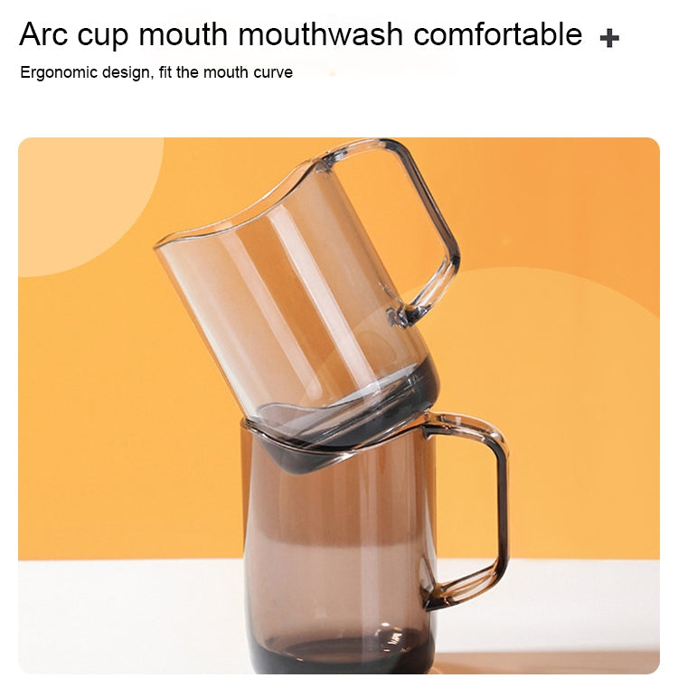 Clear acrylic mouthwash cup with side handle, angled view