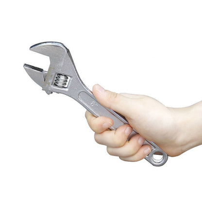 Chrome adjustable wrench held in hand, open jaw with knurled adjustment screw