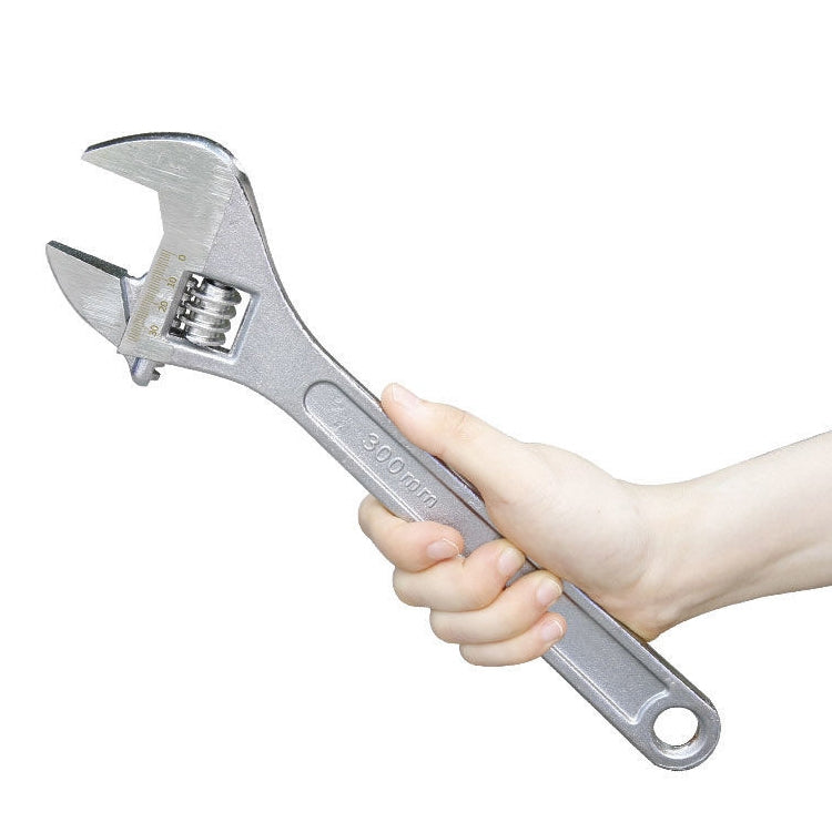 Chrome adjustable wrench held in hand, 300mm length marking on handle