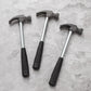 Three mini claw hammers with black handles and steel claw heads