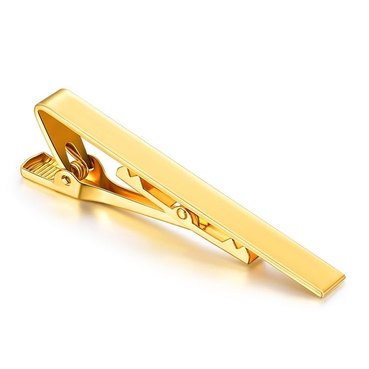 Gold tie clip with rectangular bar and spring hinge, close-up