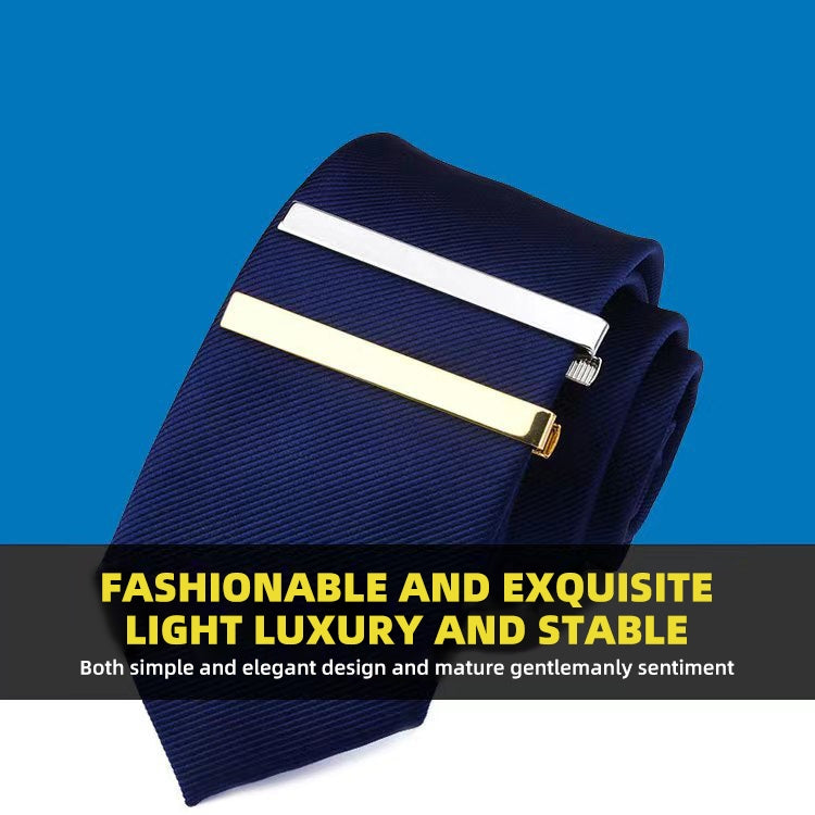 Gold tie clip holding a navy dress tie