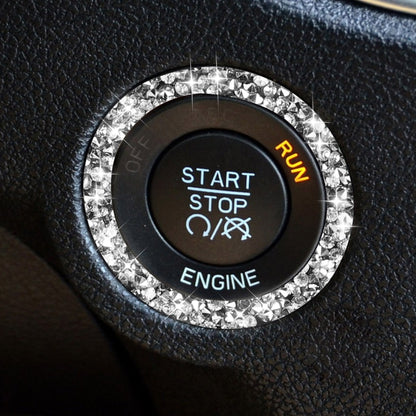 Black circular engine start/stop sticker ringed with silver rhinestone; START STOP ENGINE text