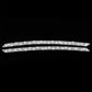 Two silver glitter eyebrow strips for car headlights on dark background