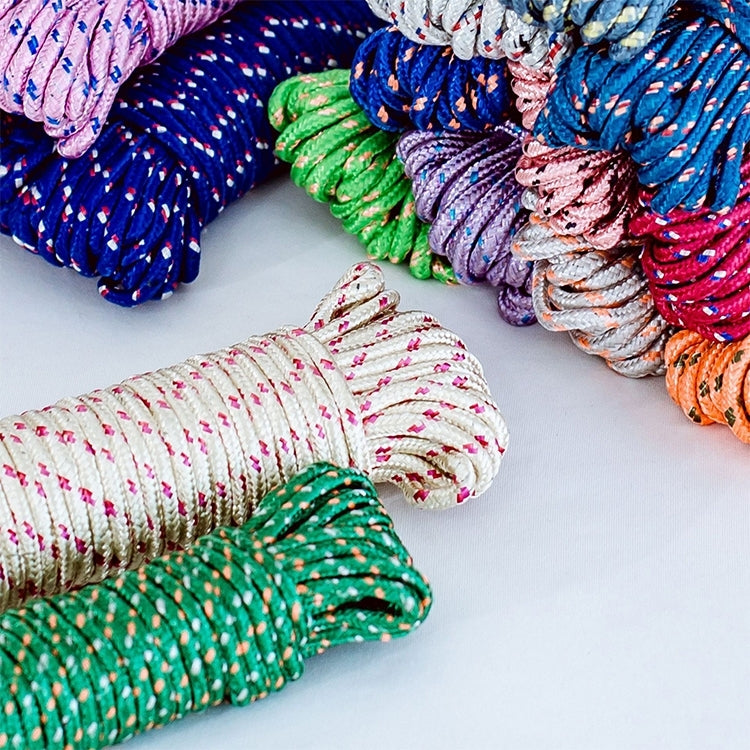 Thick nylon hanging rope close-up, coiled multicolor strands in green purple and pink