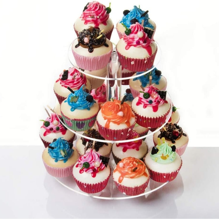 Three-tier clear acrylic cupcake stand with multiple cupcakes arranged on each tier