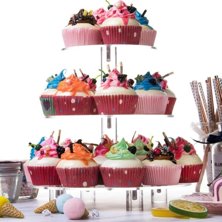 Three-tier clear acrylic cupcake stand with cupcakes on all three round tiers