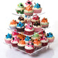 Three-tier clear acrylic cupcake stand featuring cupcakes arranged across levels