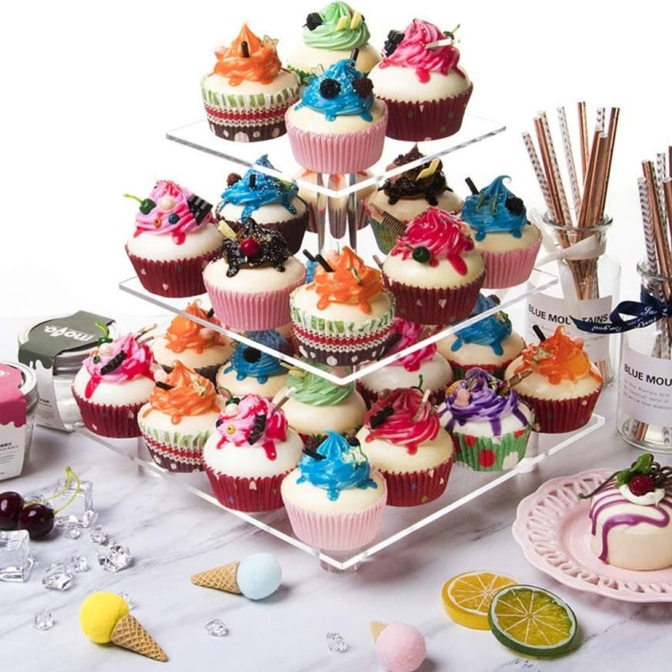 Clear 3-tier acrylic cupcake stand with multiple cupcakes and colorful toppers