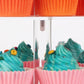 Cupcakes around the chrome post of a clear 4-tier acrylic square cupcake stand