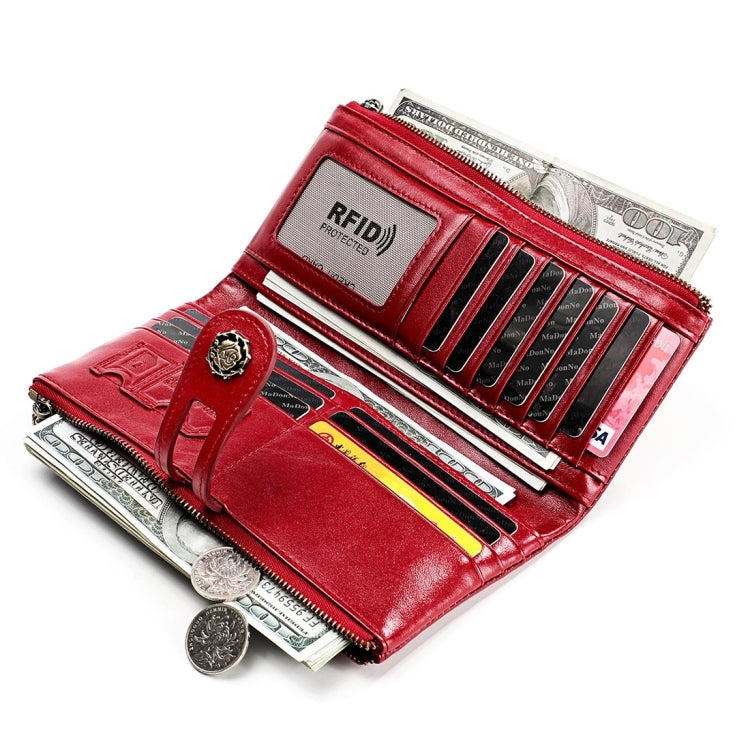 Red leather wallet opened to show card slots and zipped money compartment.