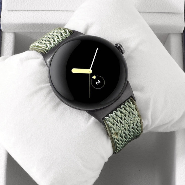 Wave braided nylon watch band in olive green, with metal clasp and zigzag knit texture.