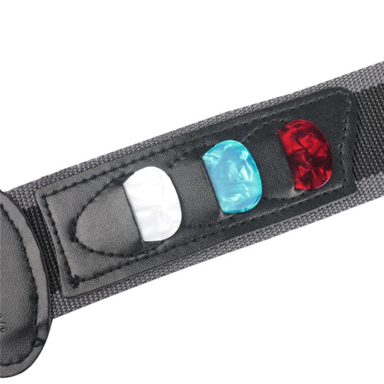 Close-up of black guitar strap pick pocket with red, blue, and white picks