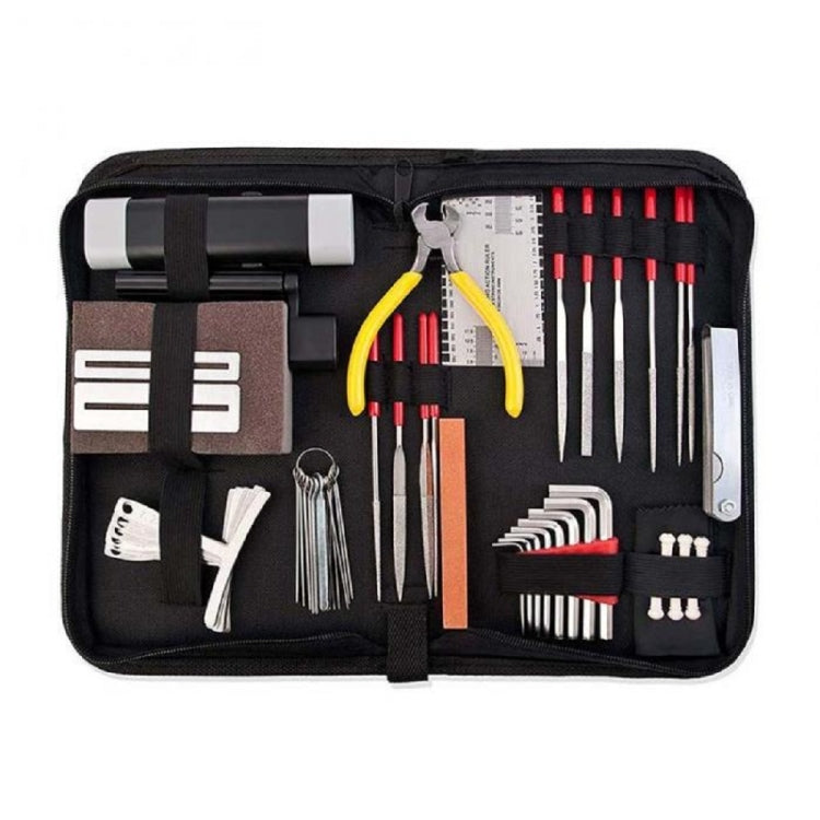 Guitar repair tool set in black roll-up case with assorted metal tools