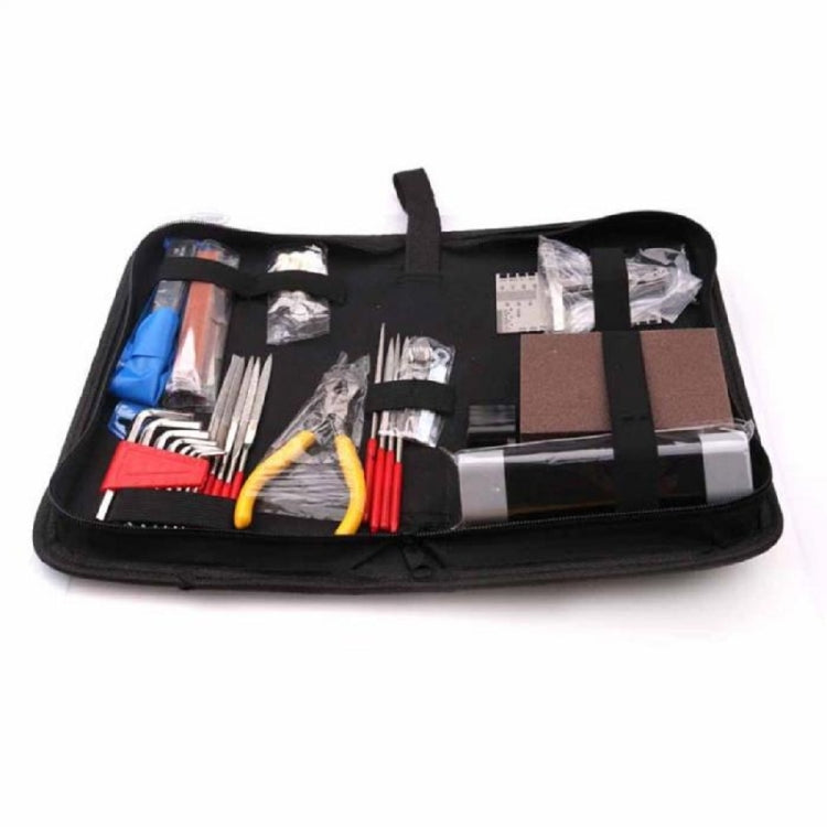Guitar repair tool set opened in black pouch with multicolor-handled tools