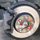 Brake disc rotor with fixing screws installed; two screws highlighted for replacement