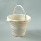 Creamy white silicone folding bucket with side handle and wide rim