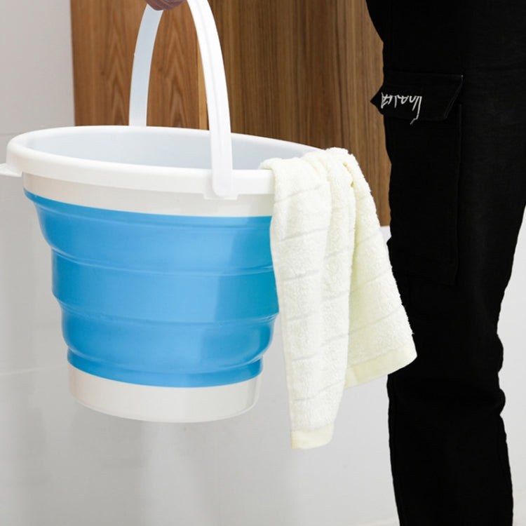 Blue silicone folding bucket with white handle, holding a folded towel