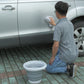 White silicone folding bucket outdoors, compact collapsible design