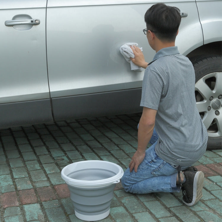 White silicone folding bucket outdoors, compact collapsible design