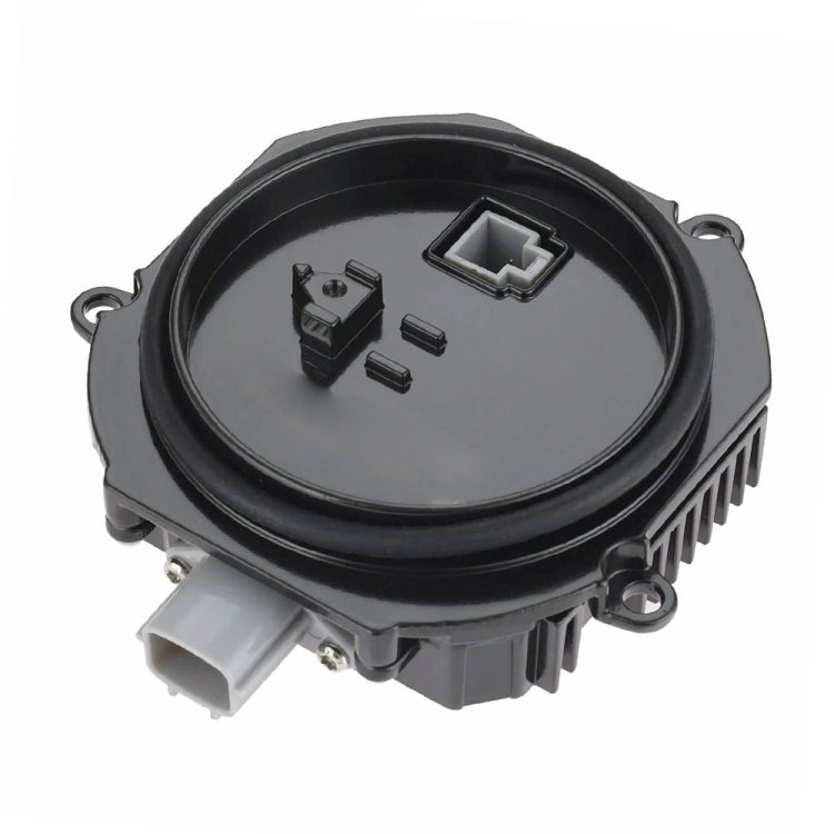 HID ballast module with black circular housing and electrical connectors
