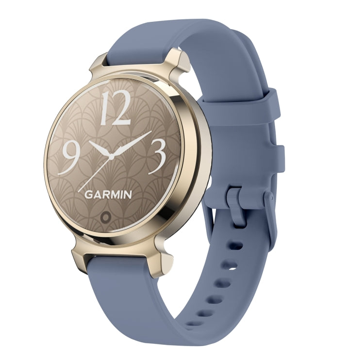Garmin Lily 2 watch with a blue-gray silicone band and gold-tone case
