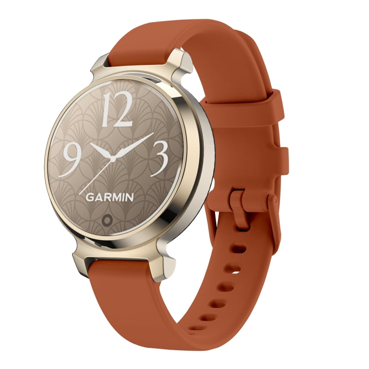 Garmin Lily 2 watch with a rust-colored silicone band and gold-tone case