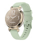 Garmin Lily 2 watch with a pale green silicone band and gold-tone case