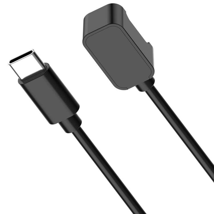Close-up of black Galaxy Fit 3 USB-C cable plug and back of watch charging connector