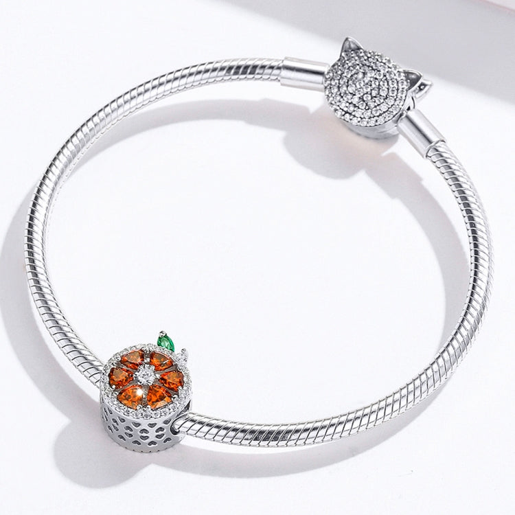 Sterling silver bracelet with grapefruit charm bead and green enamel leaf detail