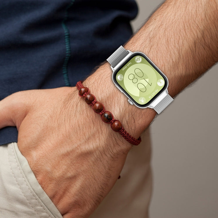 Silver Milanese metal watch band worn on the wrist
