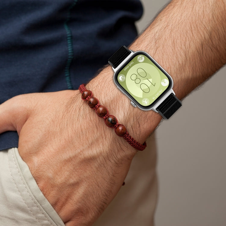 Black nylon watch band worn on the wrist with a smartwatch