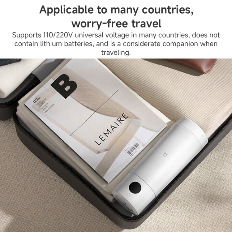White portable electric heating cup partially inside a travel pouch