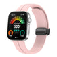 Pink silicone watch band with black magnetic buckle shown on a smartwatch
