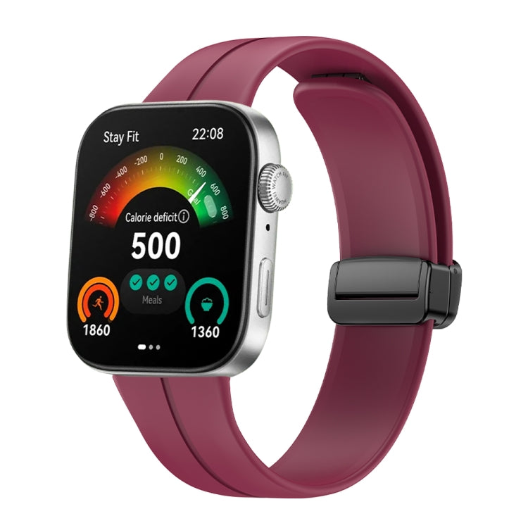 Wine-red silicone watch band with black magnetic buckle shown on a smartwatch