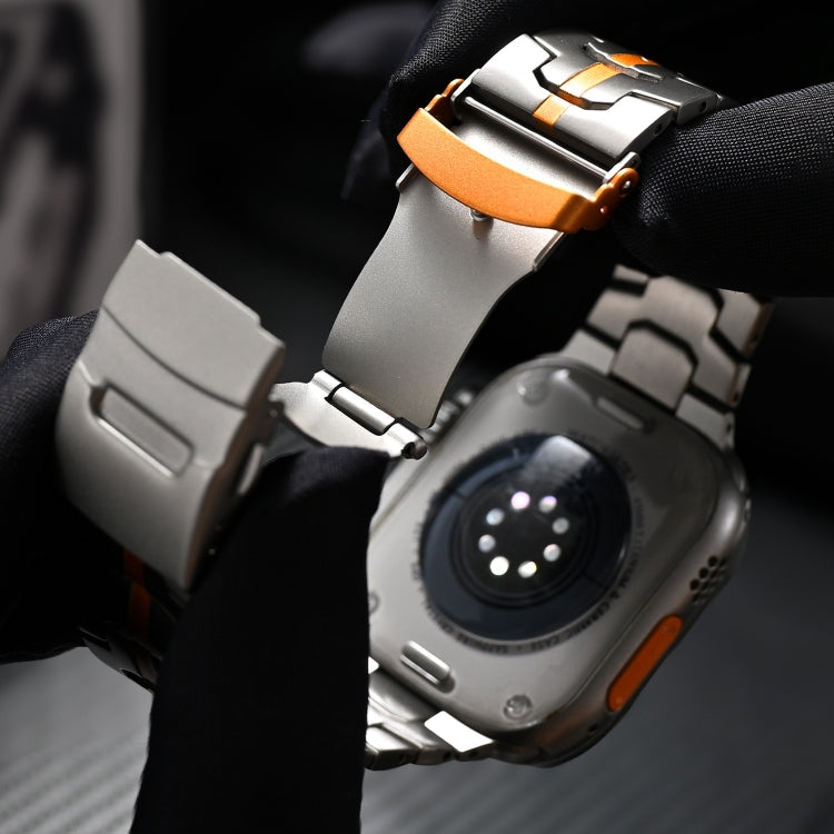 Titanium steel watch band showing its orange-accented double-lock clasp and watch connector